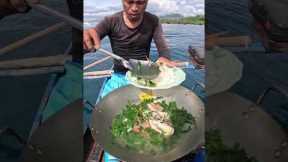 Cooking fresh fish after catch in a boat